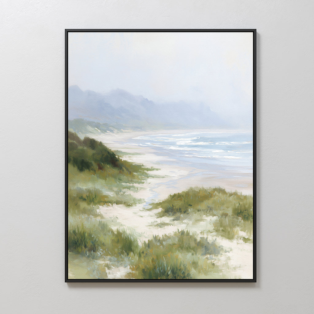 Windswept Dunes Canvas Art - Vertical features a serene beach scene with sandy shores, green grass, gentle waves, and misty mountains beneath a soft cloudy sky—perfect as calming coastal wall decor.