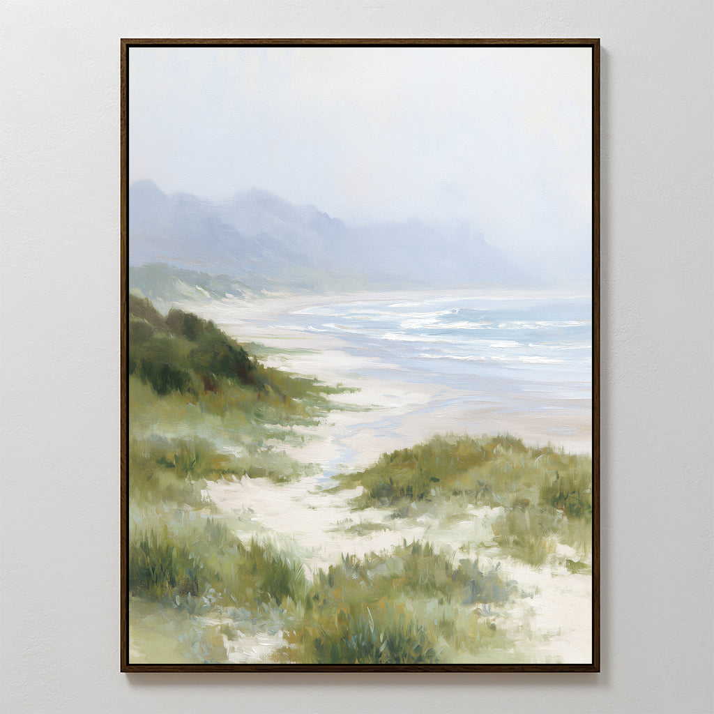 The Windswept Dunes Canvas Art - Vertical depicts gentle waves, sandy beach, and grassy dunes with misty hills beneath a cloudy sky—ideal for adding calming coastal style to any space.