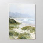 The Windswept Dunes Canvas Art - Vertical features a soft, pastel beach scene with gentle waves, grassy dunes, and hazy mountains—ideal as calming decor or coastal wall art for any serene space.