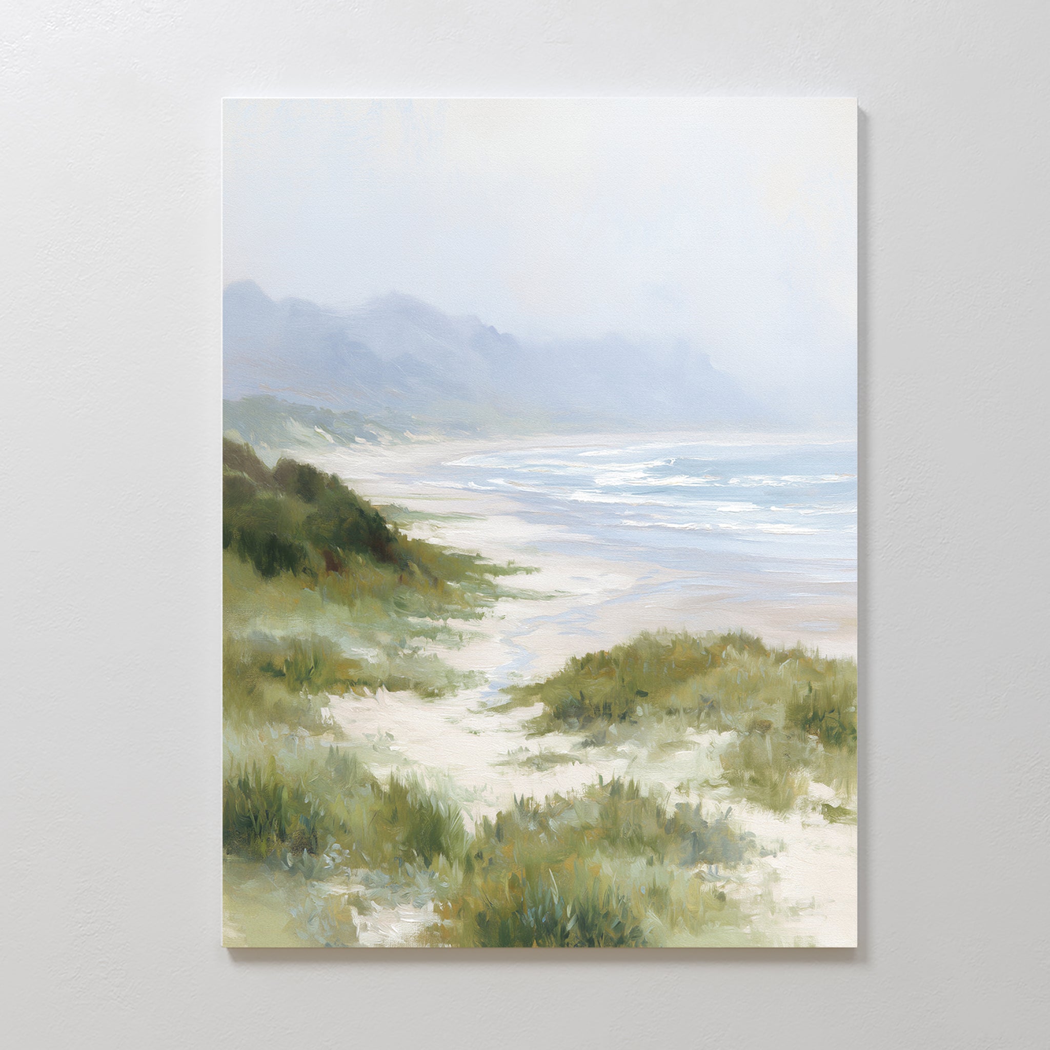 The Windswept Dunes Canvas Art - Vertical features a soft, pastel beach scene with gentle waves, grassy dunes, and hazy mountains—ideal as calming decor or coastal wall art for any serene space.