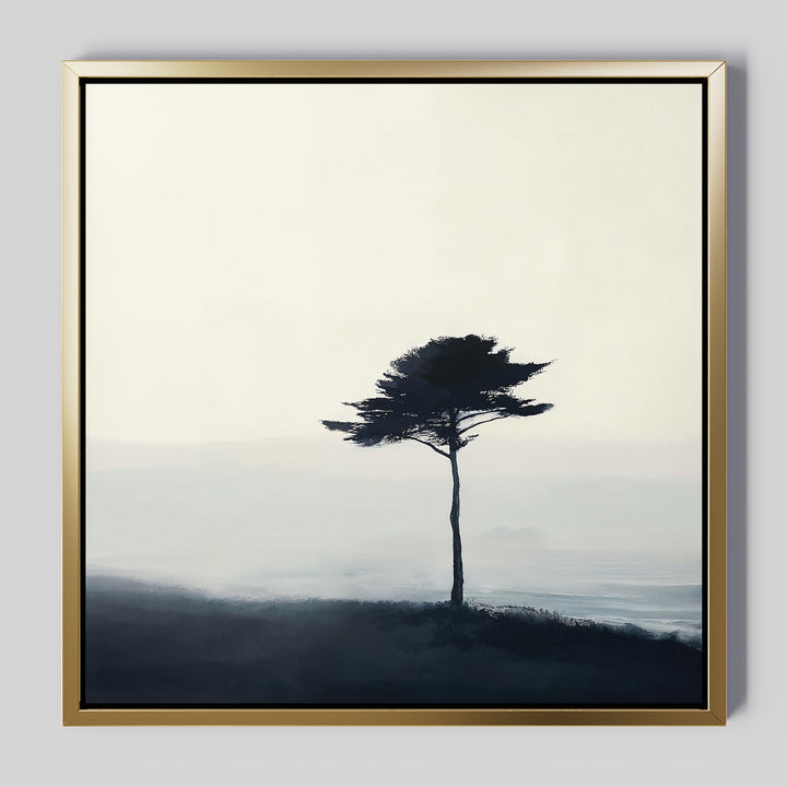 The Windswept Solitude Canvas Art - Square features a solitary tree on a misty landscape with a pale sky in a gold frame—minimalist wall art ideal for adding modern elegance to your living room decor.
