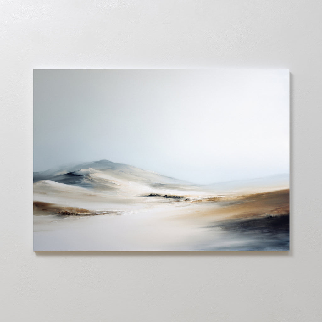 Winter Plains Canvas Art - Horizontal features a minimalist, blurred desert landscape with gentle dunes and soft hills beneath a pale, cloudy sky, adding serene style when displayed on a white wall.