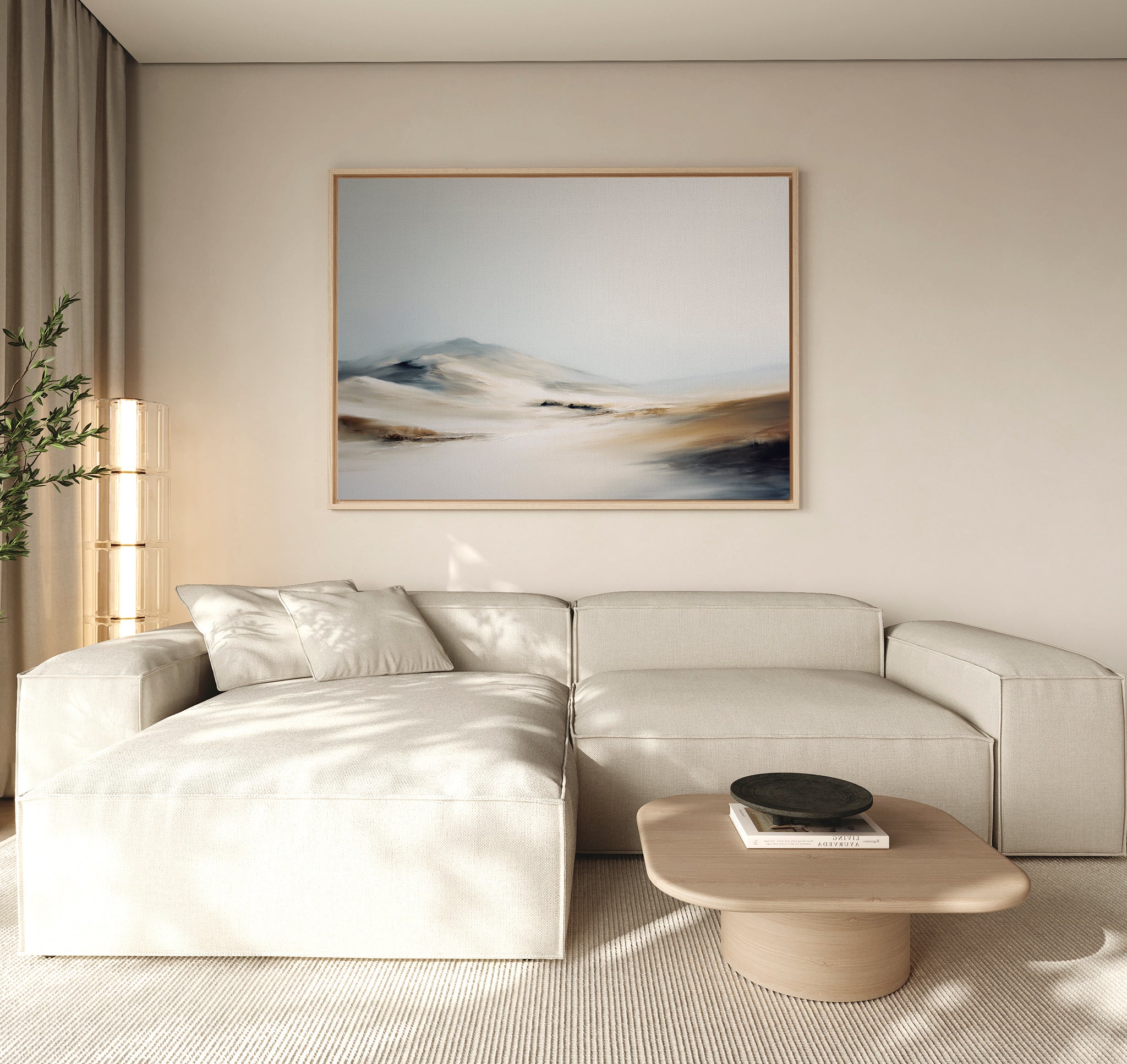 A modern, minimalist living room with a light beige sectional sofa, a low wooden coffee table, and the "Winter Plains Canvas Art - Horizontal" hanging above the sofa. Soft natural light filters through sheer curtains.