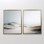 The "Winter Plains - Set of 2" features framed abstract landscape prints in soft beige, white, blue, and brown tones, creating a serene, misty vibe—ideal wall art to bring calm to any space.