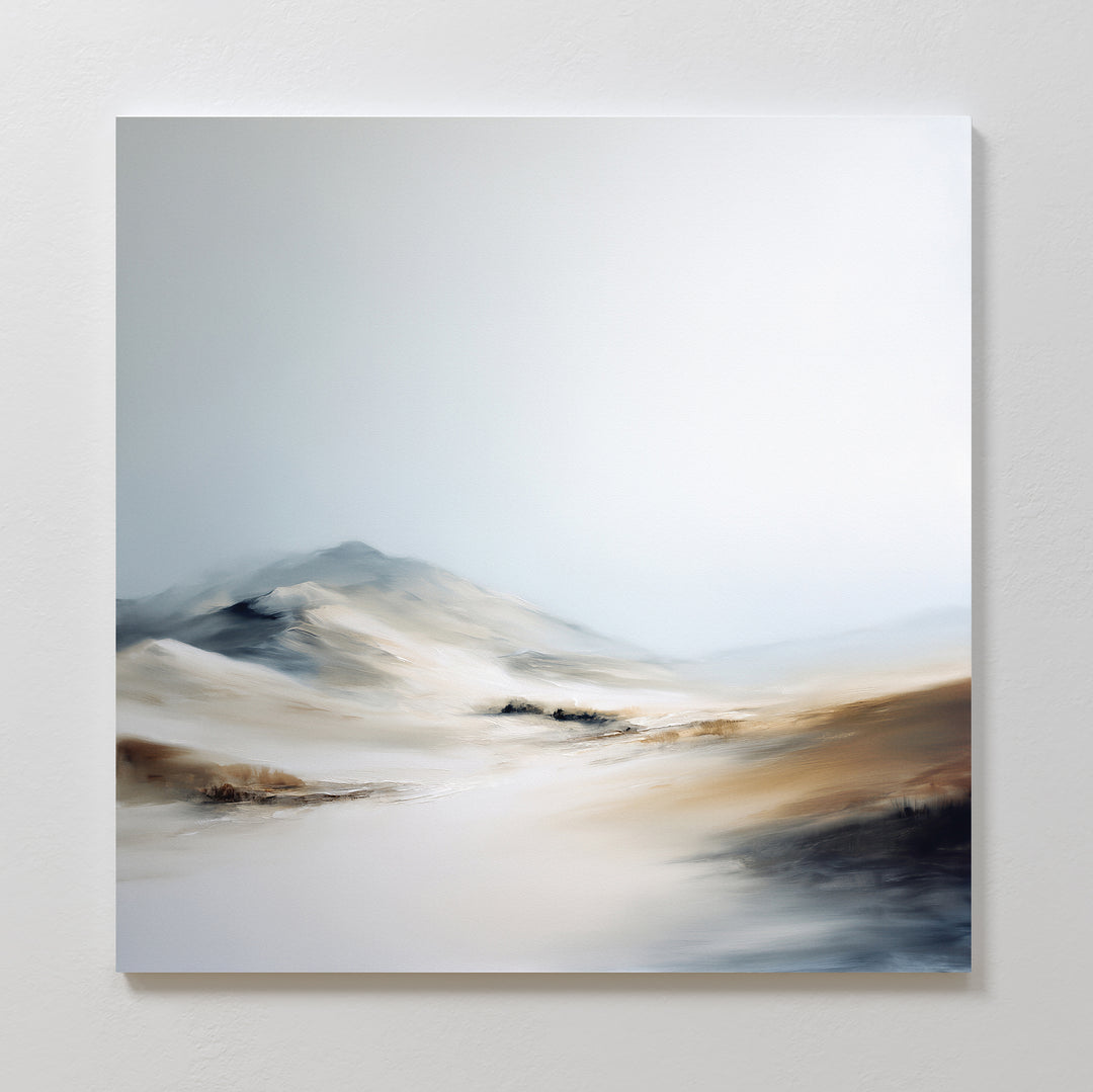 The Winter Plains Canvas Art - Square features a minimalist desert landscape in soft beige, white, and gray tones, with gentle sand dunes and distant hills beneath a pale sky for a serene touch to your space.