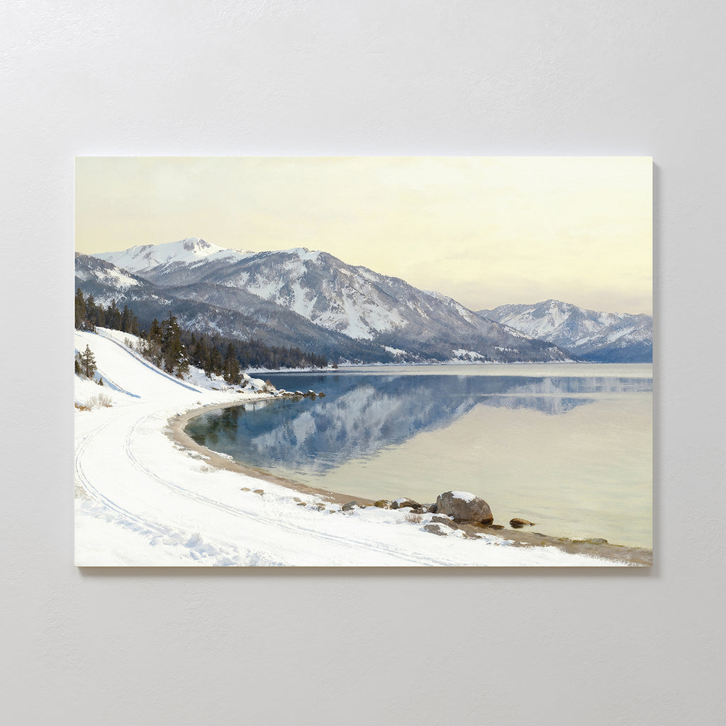 The Winter Reflection Canvas Art - Horizontal showcases a tranquil snowy shoreline beside a calm alpine lake, with distant mountains and pine trees, perfect for adding serenity to your landscape decor.