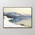 Winter Reflection Canvas Art - Horizontal features a serene, snow-bordered alpine lake with distant mountains and a winding path beneath a cloudy sky—perfect landscape decor for any space.