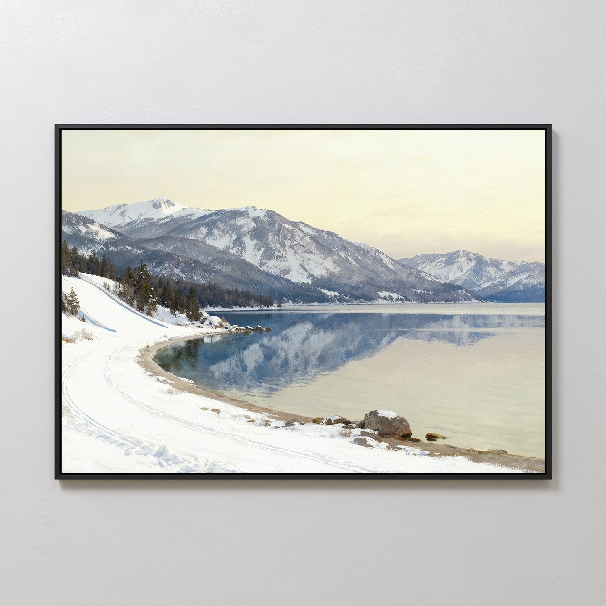Winter Reflection Canvas Art - Horizontal: A framed alpine lake photo featuring snowy mountains, calm reflective water, and a snow-covered path under a soft yellow sky—the perfect serene landscape decor.