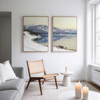 A living room with a couch and chair is beautifully accented by the Winter Reflection - Set of 2 wall art, bringing serene alpine lake beauty to the space.