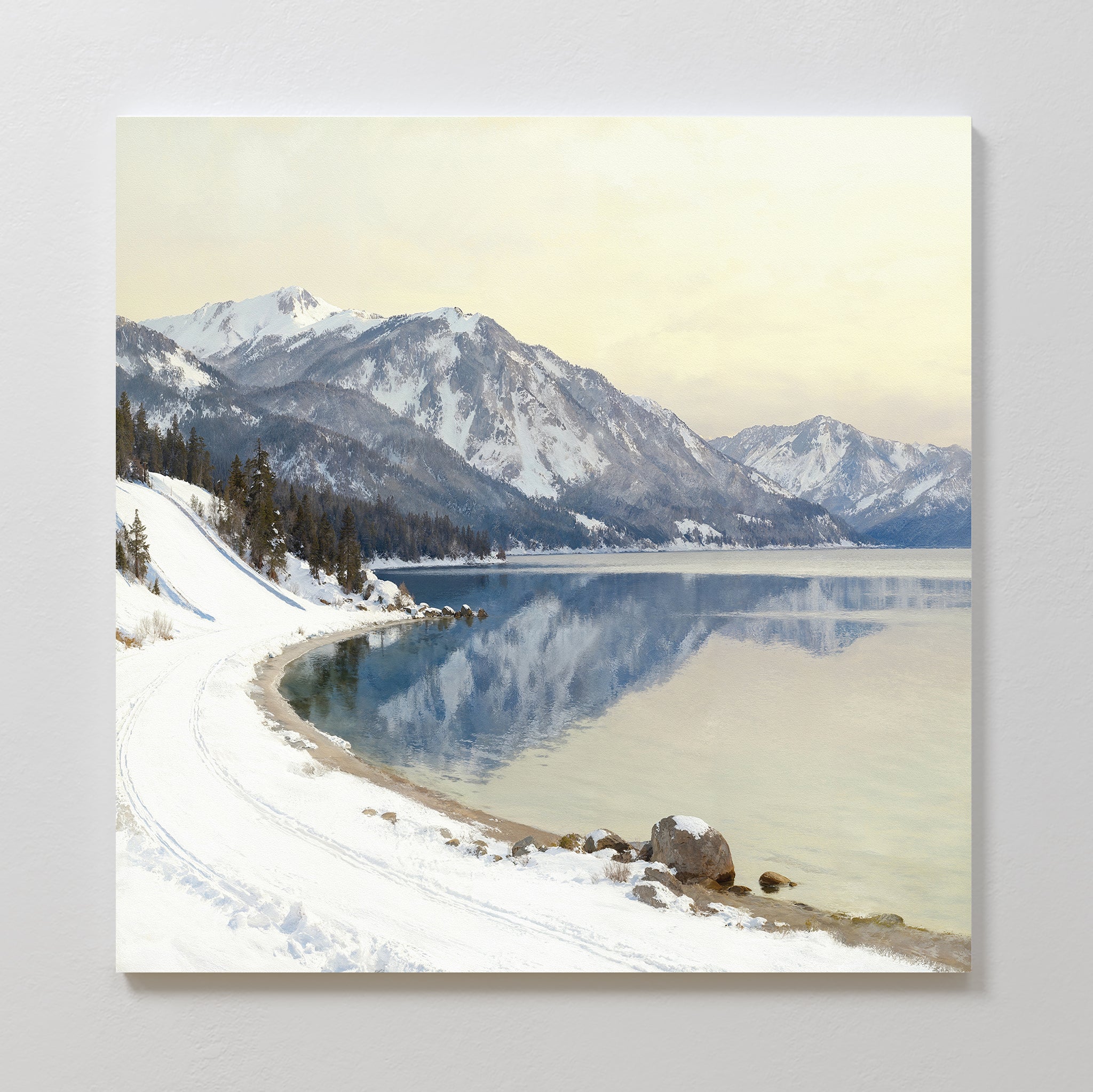 Transform your space with "Winter Reflection Canvas Art - Square," showcasing snow-covered mountains, a tranquil alpine lake, and a winding, snow-lined road—an ideal winter canvas print for your home.