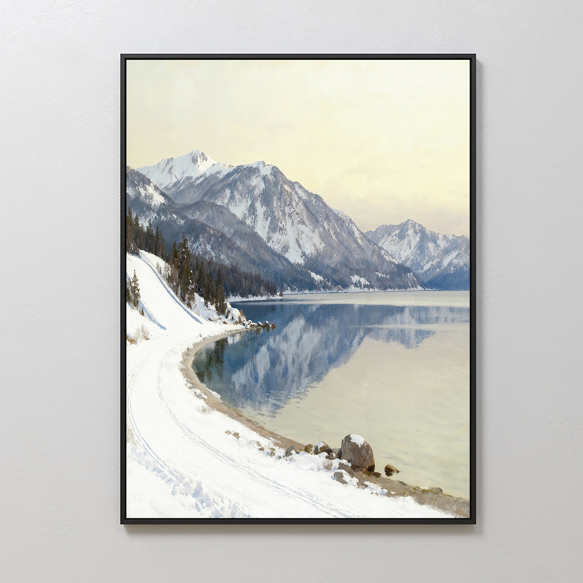 The Winter Reflection Canvas Art - Vertical features a snowy lakeside road with mountains and calm waters, creating stunning Alpine lake wall art ideal for Nordic Park-inspired spaces.