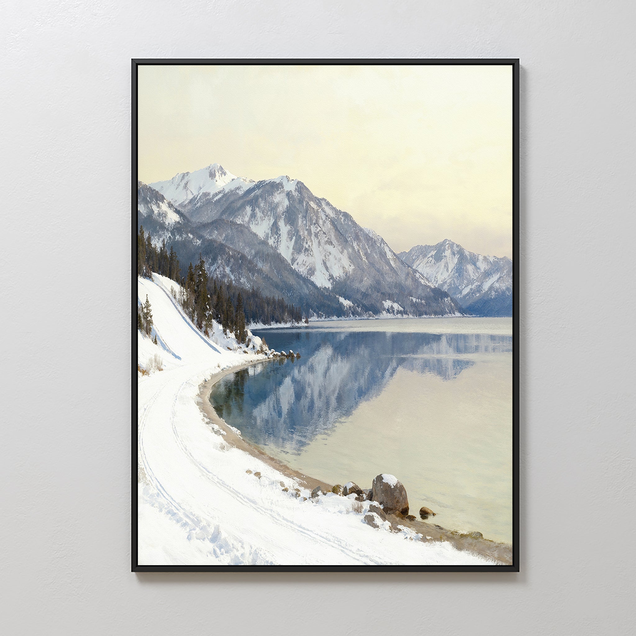 The Winter Reflection Canvas Art - Vertical features a snowy lakeside road with mountains and calm waters, creating stunning Alpine lake wall art ideal for Nordic Park-inspired spaces.