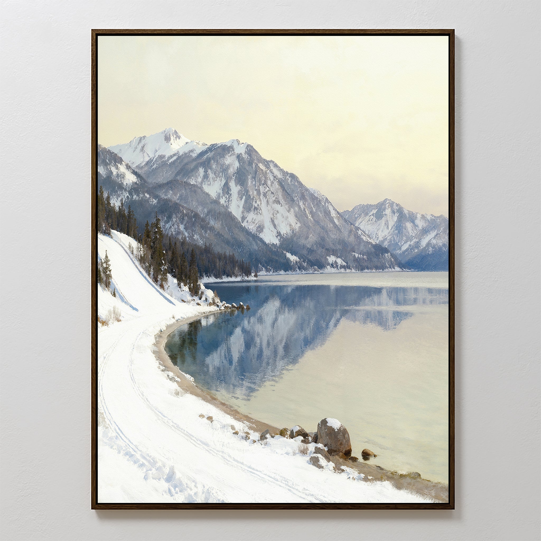 Winter Reflection Canvas Art - Vertical features a snow-covered lakeshore with a winding path, pine trees, and distant mountains mirrored in calm water—stunning alpine lake wall art for your home.