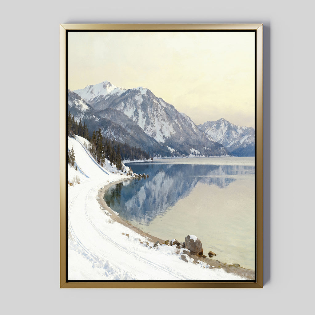 Bring tranquil vibes to your space with the Winter Reflection Canvas Art - Vertical, featuring a serene winter landscape of snow-covered mountains, winding path, evergreens, and an alpine lake under a pale sky—perfect for your wall.