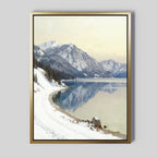 Bring tranquil vibes to your space with the Winter Reflection Canvas Art - Vertical, featuring a serene winter landscape of snow-covered mountains, winding path, evergreens, and an alpine lake under a pale sky—perfect for your wall.