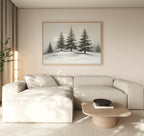 A minimalist living room with a beige sectional, light wood coffee table, and potted plant features the Winter Solitude Canvas Art - Horizontal. Natural light fills the space, evoking calm reminiscent of tranquil bedroom decor.